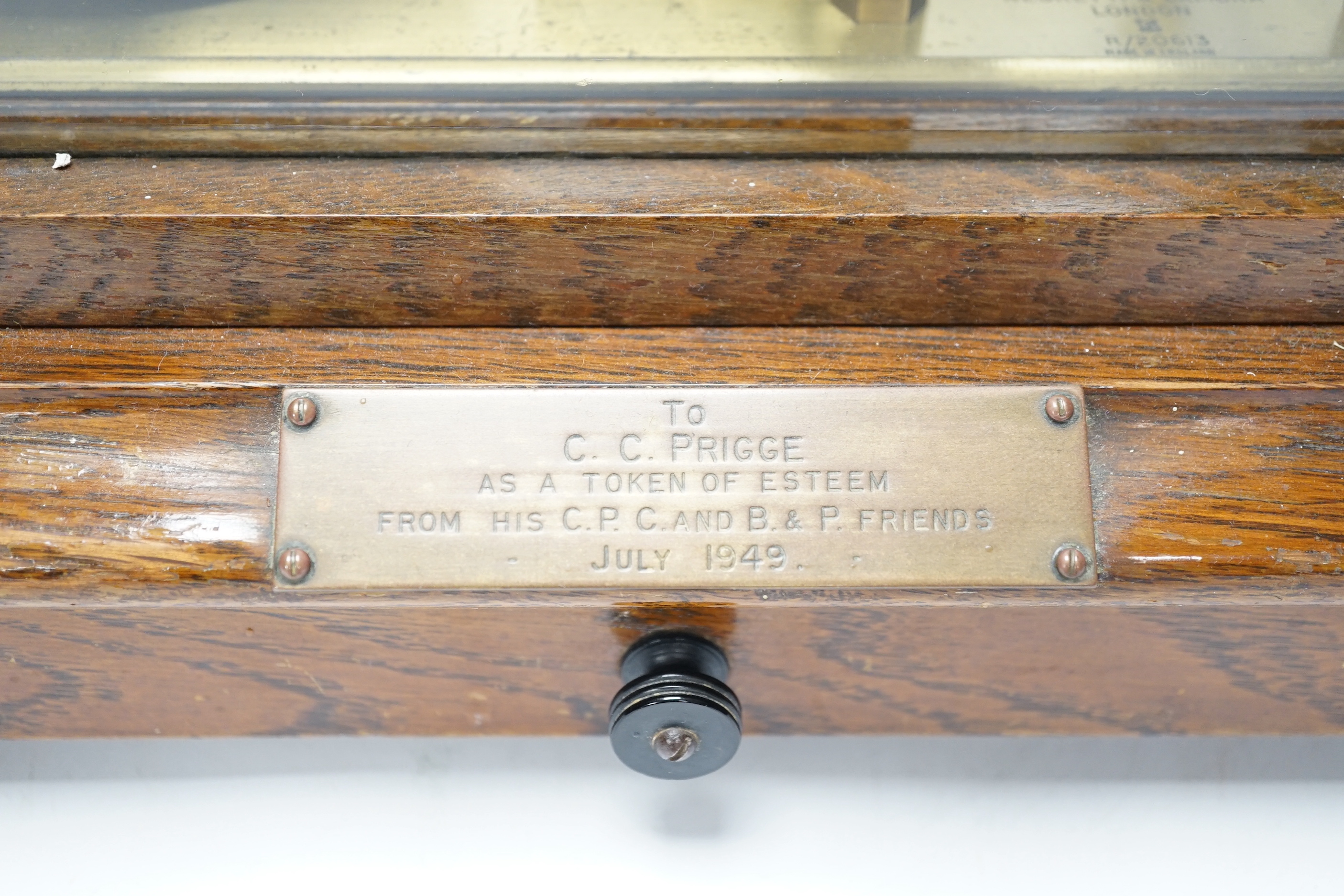 A Negretti and Zambra oak-cased barograph, number R/20613 with plaque reading ‘To C.C. Prigge as a token of esteem from his C.P.C. and B&P friends, July 1949’